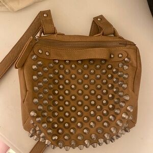Nude crossbody bag with stud grommets